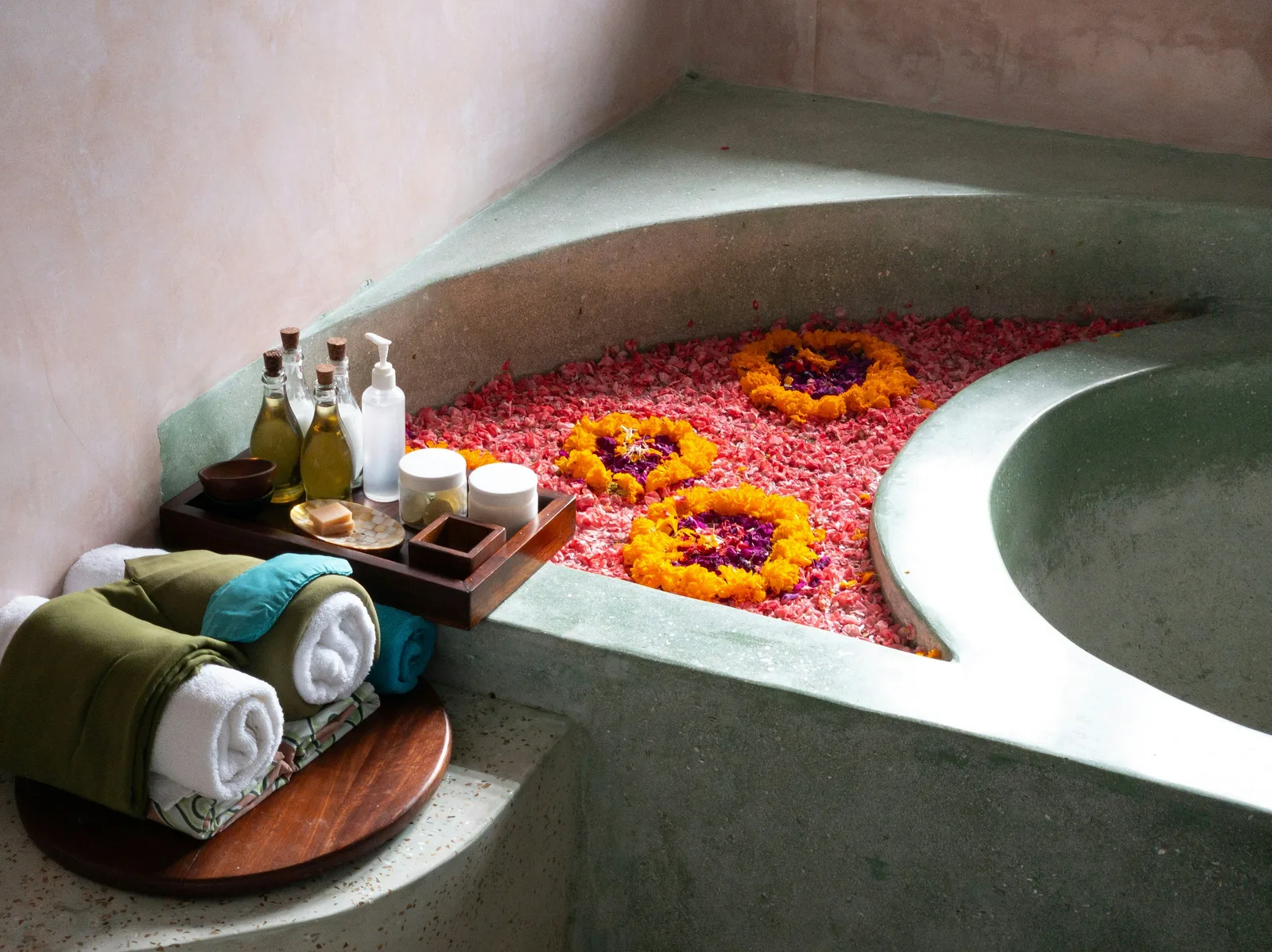 Flower-filled Balinese spa bath with oils and petals
