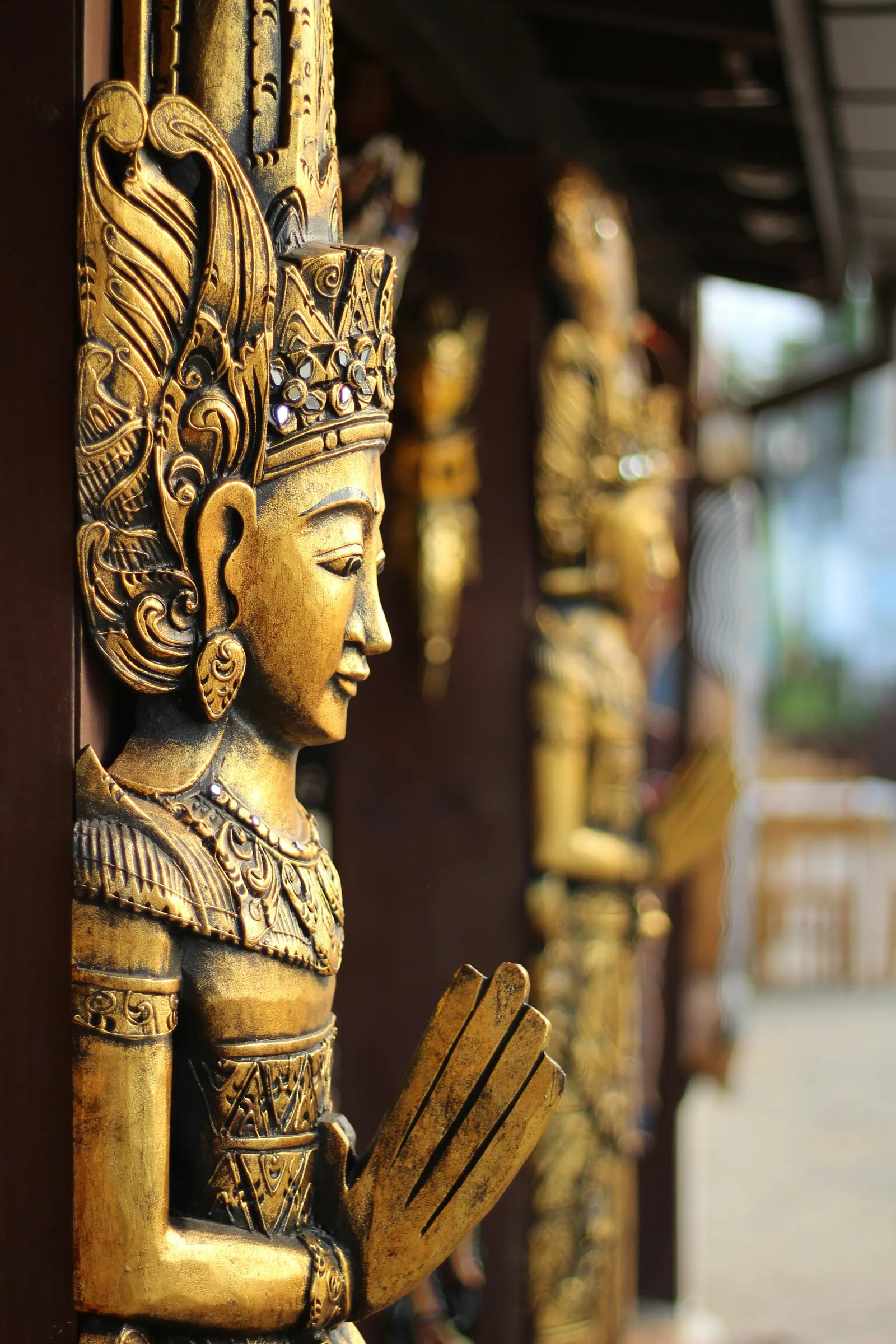 Carved Balinese statue in warm candlelight